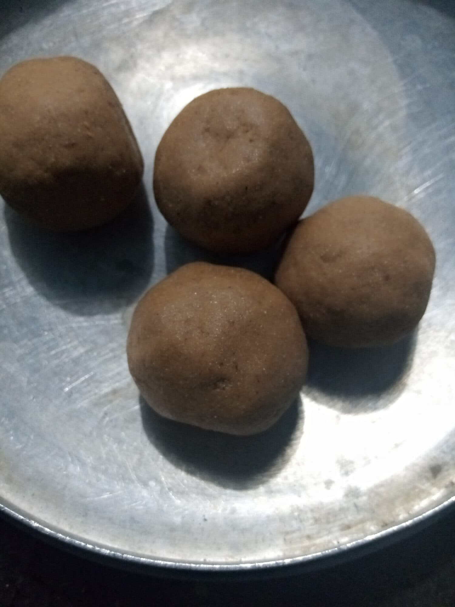 Four balls of dakoa in a metal bowl