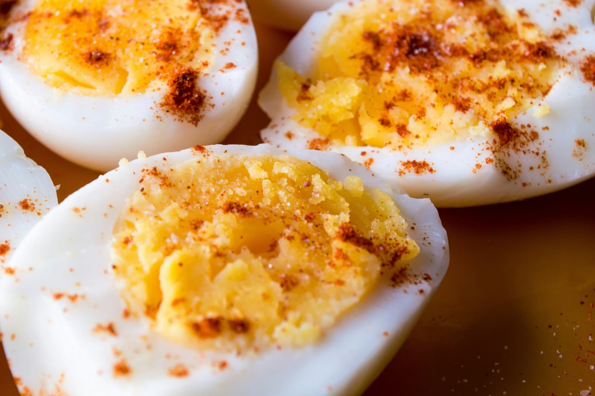 Halved boiled eggs dusted with ground pepper